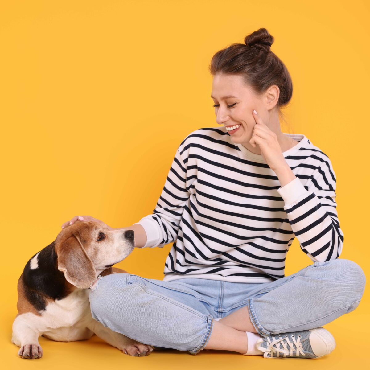 Happy,Young,Woman,With,Cute,Beagle,Dog,On,Orange,Background.